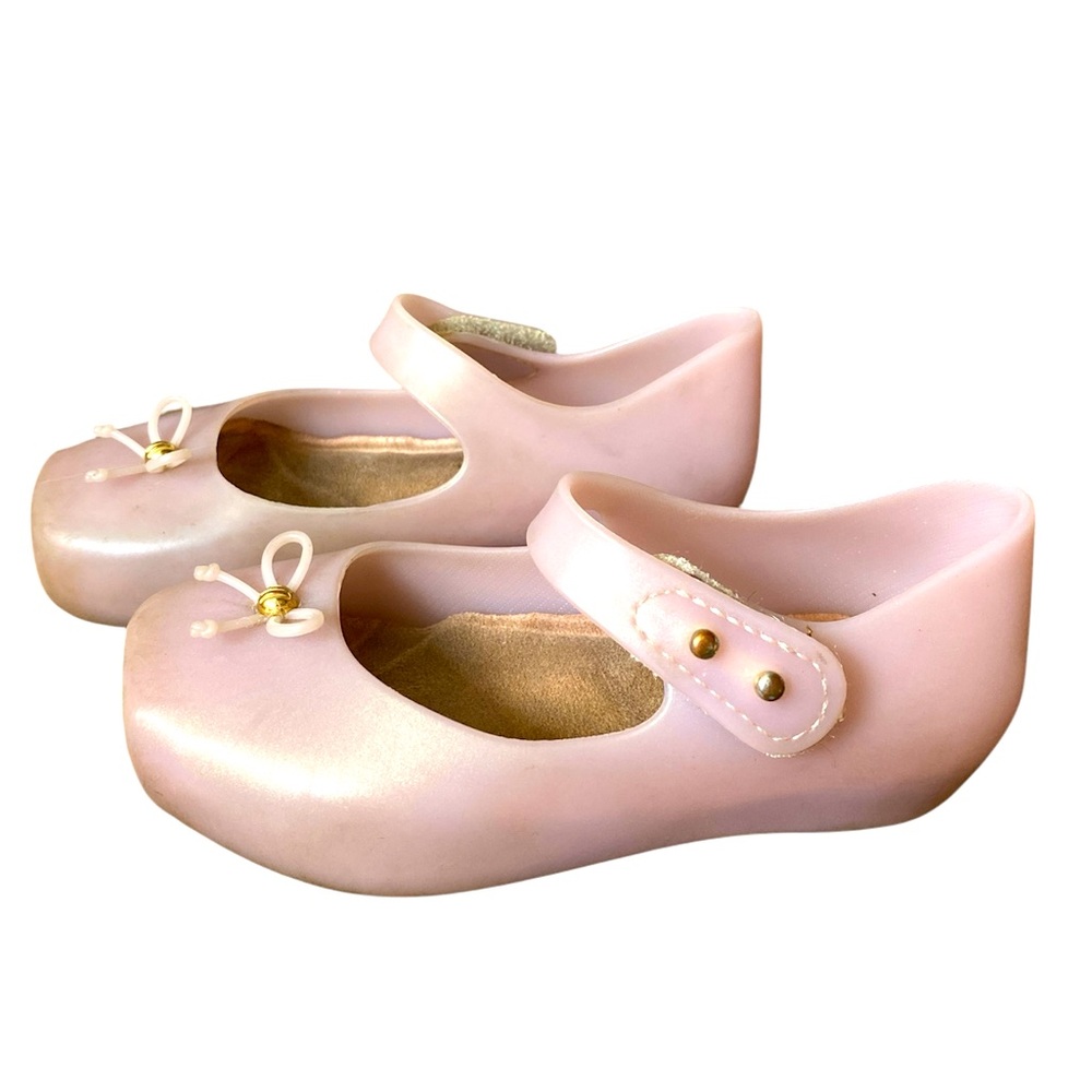 Light pink mini Melissa slippers.